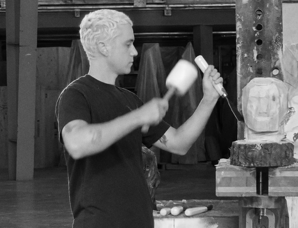 Francesco Papetti carving a wooden head in the studio